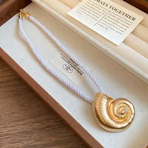 Elegant vintage metal conch shell pendant necklace with white twisted silk rope chain