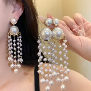 Detailed view of elegant pearl tassel earrings with silver needle in French retro style