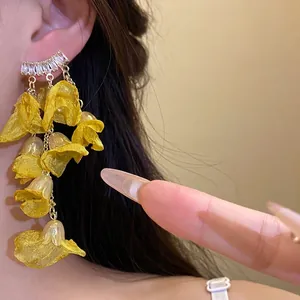 Yellow chiffon flower tassel earrings with zircon studs for a romantic vacation look.