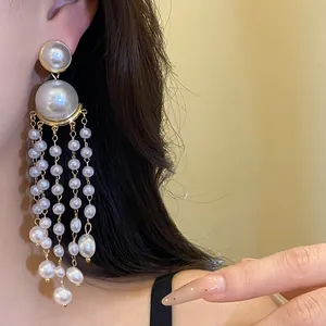 Close-up of elegant pearl beaded tassel earrings in a French vintage style for women.