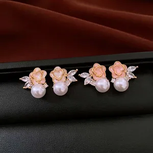 Elegant vintage-style floral pearl stud earrings with shimmering marquise-cut zircons.