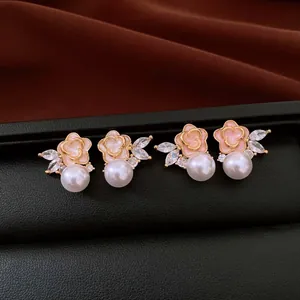 Detailed macro view of vintage flower pearl stud earrings with sparkling zirconia stones.