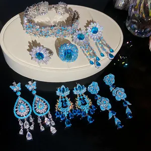 Detailed view of luxury blue zircon flower jewelry set with sparkling earrings and rings