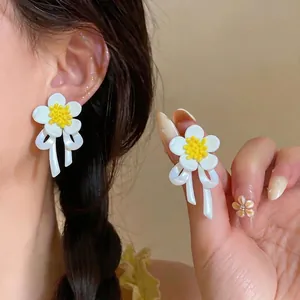 Minimalist white flower ribbon earrings with yellow stamen and S925 silver needles