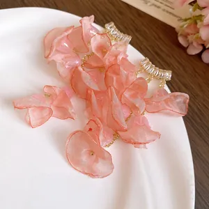 Close-up detail of romantic pink chiffon flower tassel earrings with sparkling zirconia