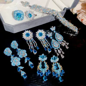 Detailed view of blue zircon jewelry set featuring floral and butterfly earrings