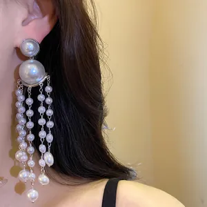 Detailed view of elegant silver needle pearl tassel earrings in French retro style