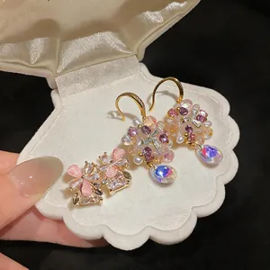 Detailed close-up of sweet colorful flower earrings with crystals in a shell jewelry box