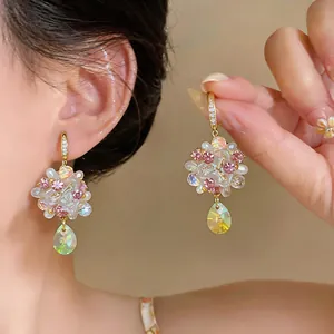 Close-up of dopamine colorful flower earrings with iridescent crystal teardrops for women