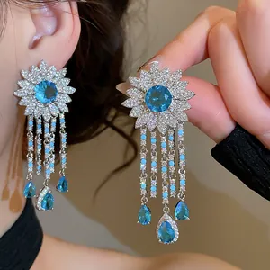 Detailed close-up of exquisite blue zircon flower tassel earrings with luxury workmanship