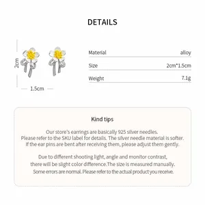 Detail showing floral stud earrings with silver needles and sparkling ribbon accents.