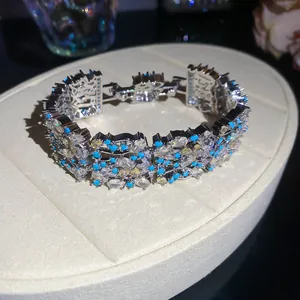 Detailed view of heavy industry silver bracelet with blue and clear zircon floral patterns