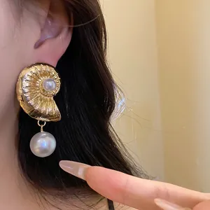 Elegant gold nautical shell earrings featuring a large luminous white pearl pendant for women
