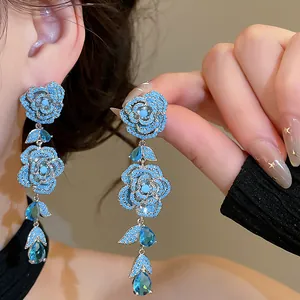 Detailed view of blue zircon flower drop earrings with intricate crystal pavé settings.