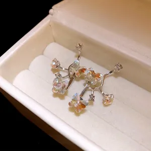 Elegant butterfly stud earrings with iridescent crystals in a white jewelry gift box