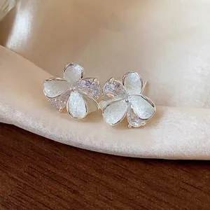 Elegant silver flower stud earrings featuring shimmering enamel and clear cubic zirconia