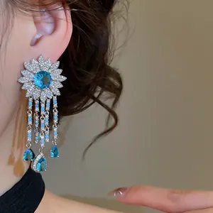 Detail view of heavy-duty blue zircon flower tassel earrings with luxury sparkle