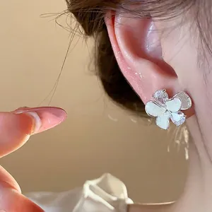 Elegant flower stud earrings with sparkling zircon stones and white enamel details