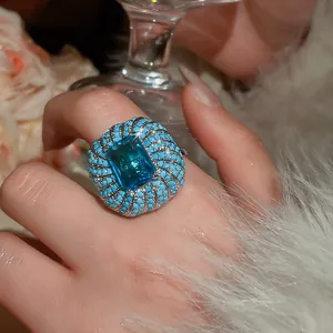 Close-up of heavy-duty blue zircon ring with turquoise beads on hand