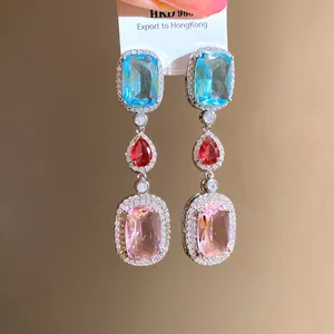 Macro detail of three-tier colorful cubic zirconia drop earrings in silver setting