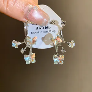 Iridescent crystal butterfly stud earrings with silver needle and sparkling rhinestones
