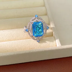 Detail shot of a luxury rectangular blue zircon ring with intricate silver setting