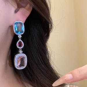 Exquisite silver needle drop earrings with blue, red, and pink zircon gemstones.