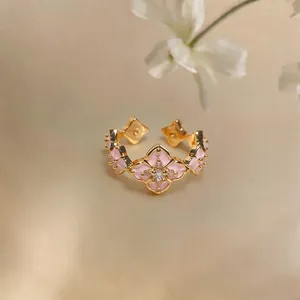 Close-up of pink enamel flower ring with sparkling zircon in 18K gold plating