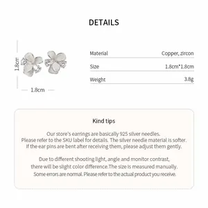 Macro detailed view of elegant silver flower stud earrings with sparkling zircon centers