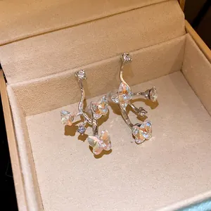 Detailed view of elegant silver needle butterfly stud earrings with sparkling crystals