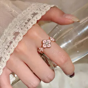Detailed macro view of 18K gold plated zircon ring with pink enamel flower design