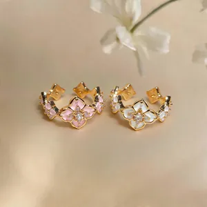 Close-up of elegant flower rings with pink and white enamel and zircon accents