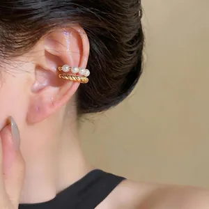 Elegant double-layer pearl and gold twisted ear cuff for non-pierced ears on model