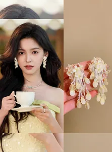 Close-up of creamy yellow flower tassel earrings with model lifestyle wearing view.
