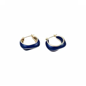 Elegant 14k gold plated irregular hoop earrings with a deep blue enamel finish.