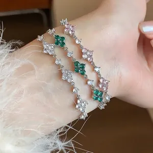 Elegant stackable set of three dainty zircon flower bracelets in green, pink, and white