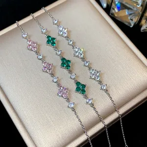 Close-up of sparkling zircon flower bracelets in pink, green, and white