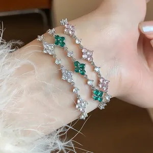 Detail view of three flower bracelets with white, green, and pink zircon stones.
