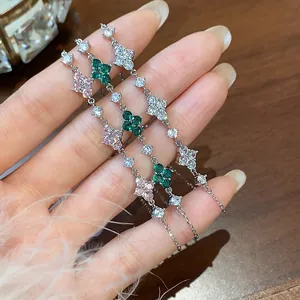 Close-up of three elegant clover bracelets with pink, green, and white cubic zirconia