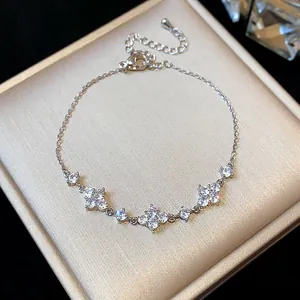 Detailed view of a silver zircon flower bracelet displayed on a beige jewelry box