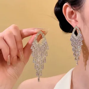 Detail view of sparkling zircon tassel chandelier earrings for a luxury look.