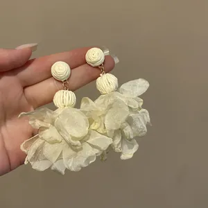Detaillierte Nahaufnahme der zarten weißen Mesh-Blütenblätter dieser eleganten Ohrringe