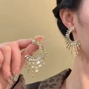 Exaggerated sunburst fringe earrings with sparkling zirconia crystals for a luxury look