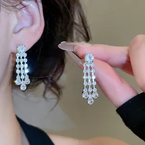 Detailed view of sparkling cubic zirconia tassel earrings with silver-tone finish.