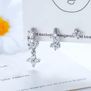 Elegant silver four-leaf star zircon earring set with hoops and studs displayed on card
