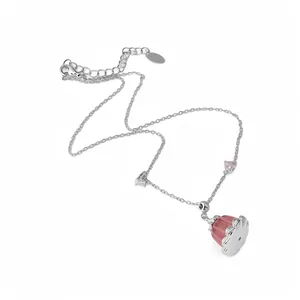 Dainty silver chain necklace featuring a pink resin pudding pendant and heart zircon charms