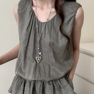 Detail of French style long pearl necklace with heart pendant on model