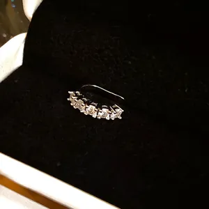 Detailed view of silver-plated ear cuff featuring five sparkling round-cut zircons