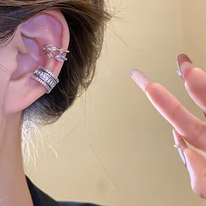 Close-up of elegant silver-plated zircon layered ear cuffs shown on a female model's ear