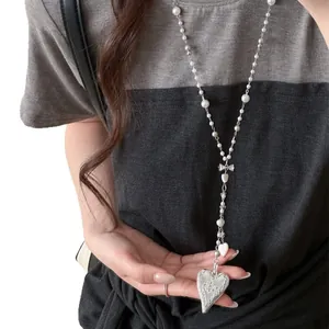 Elegant French style long necklace featuring pearls and a vintage engraved heart pendant